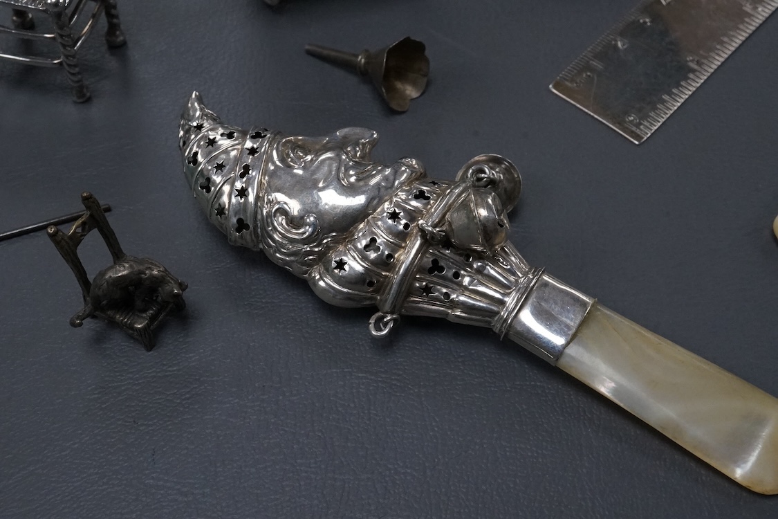 A small group of collectable silver including a Dutch miniature silver cradle box, import marks for London, 1898, 53mm, two other white metal miniature items including a chair, a continental 930 white metal taste vin, a